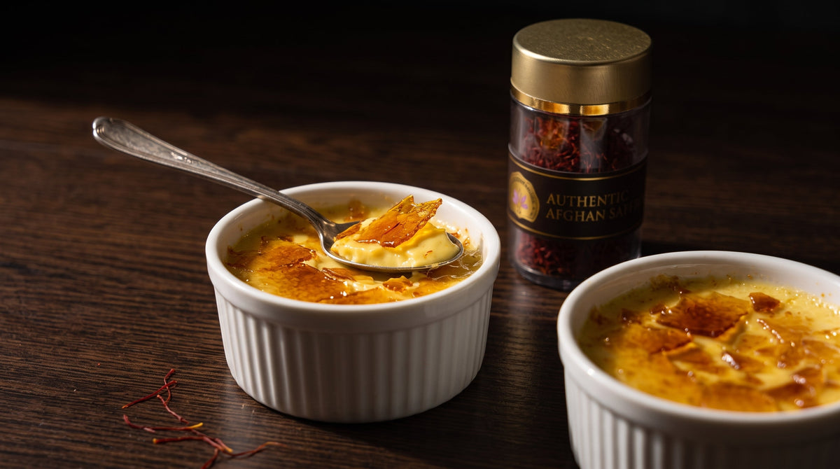 Saffron creme brulee in white ramekins with a cracked caramel crust, beside a jar of Authentic Afghan Saffron threads