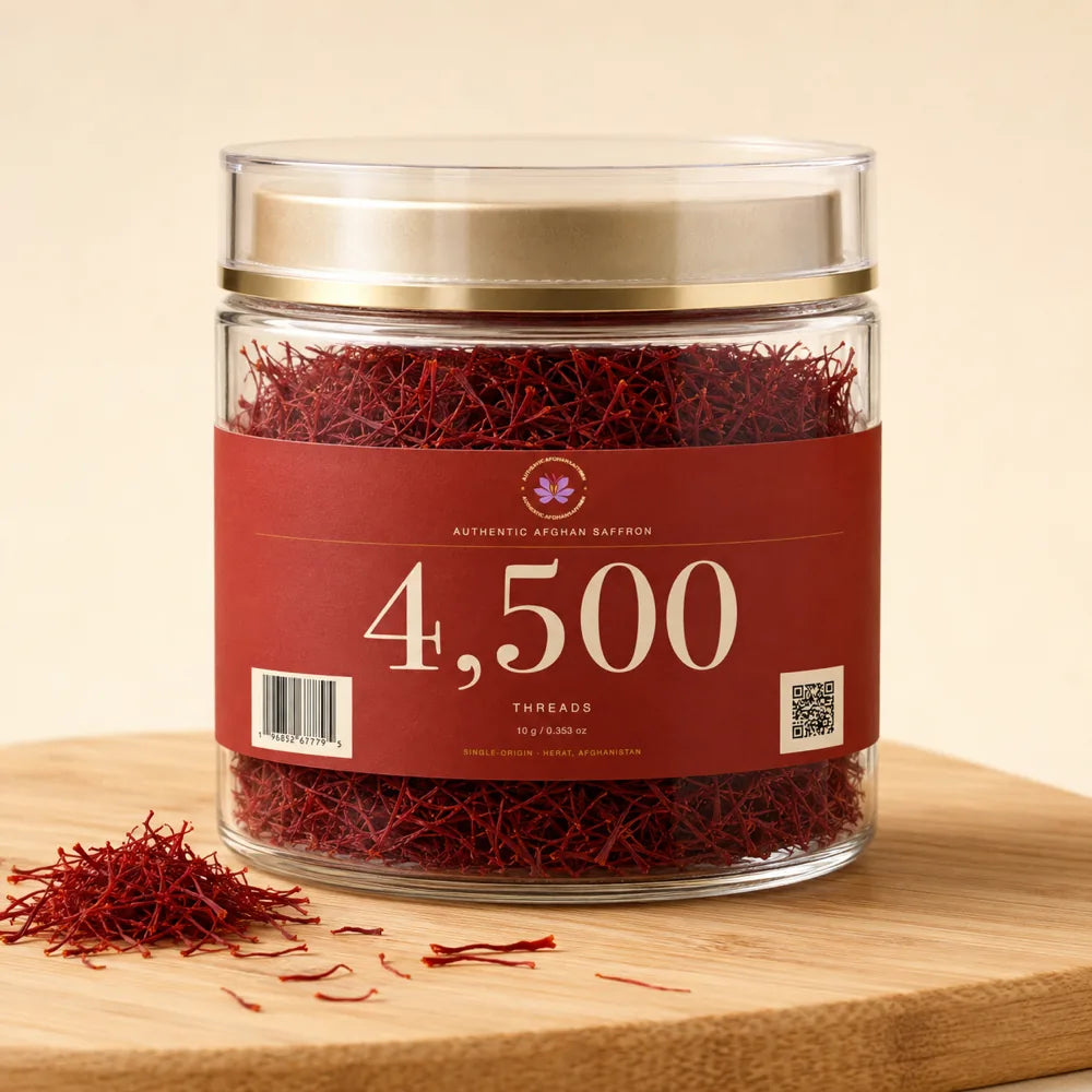 A 10 gram crystal jar of all-red Afghan Super Negin saffron threads, labelled 4,500 threads, on a wooden board.